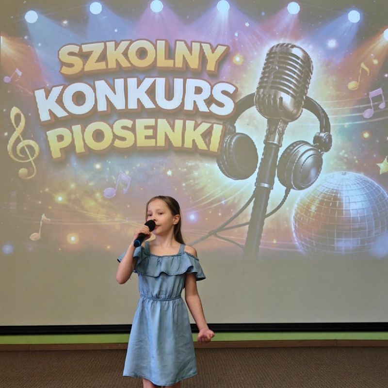 dziecko śpiewające na tle baneru szkolny konkurs piosenki