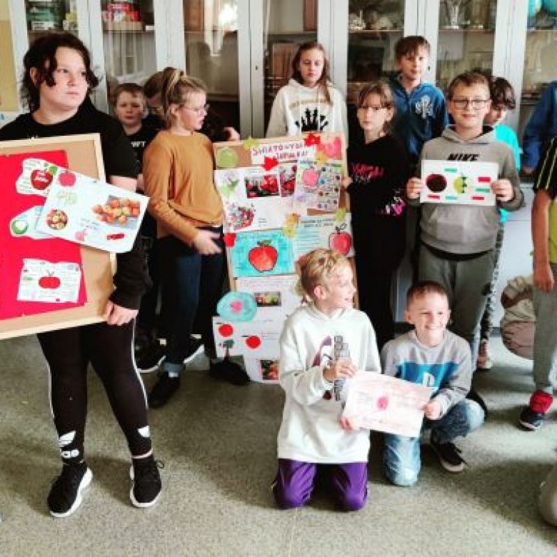 dzieci trzymające plakaty o jabłkach