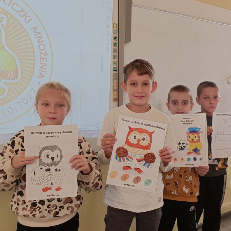 Dzieci klasy 3 z pokolorowanymi sowami